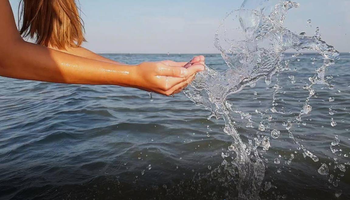 Immagine di una mano che raccoglie acqua