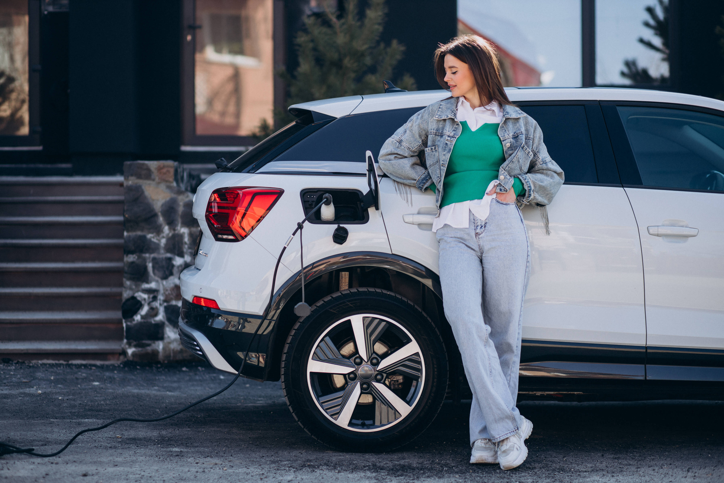 donna che ricarica la sua auto elettrica